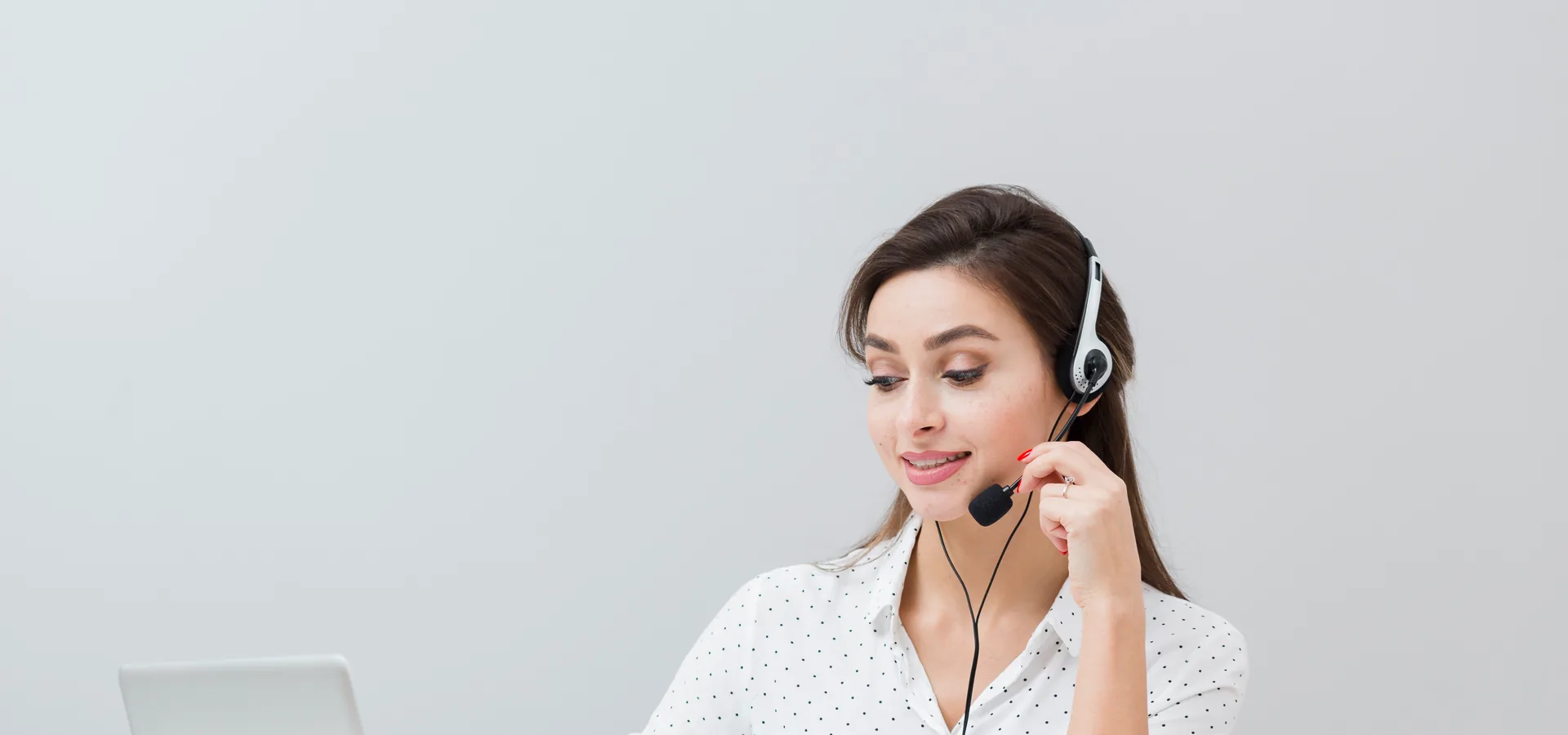 Professional virtual assistant working at a desk with headset and laptop